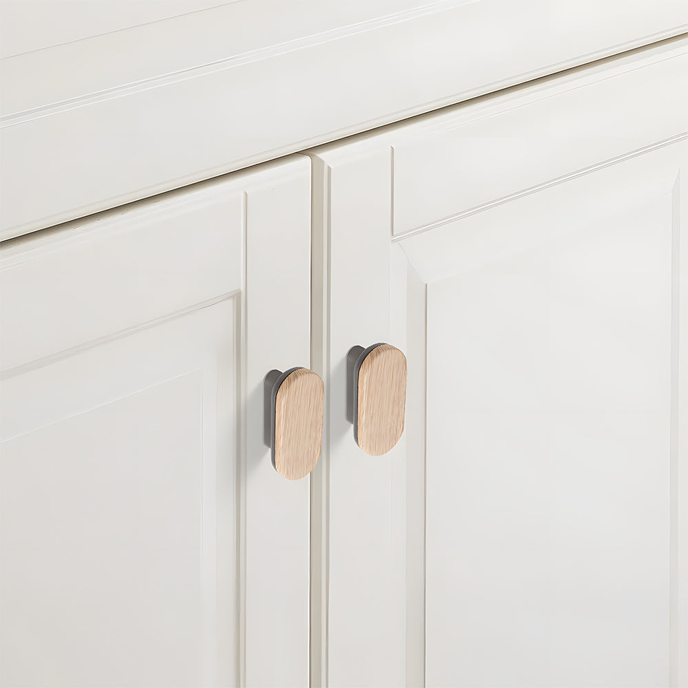 Wood-grain cabinet pull, shown in a close installed view across cabinet fronts, with the finish clearly visible