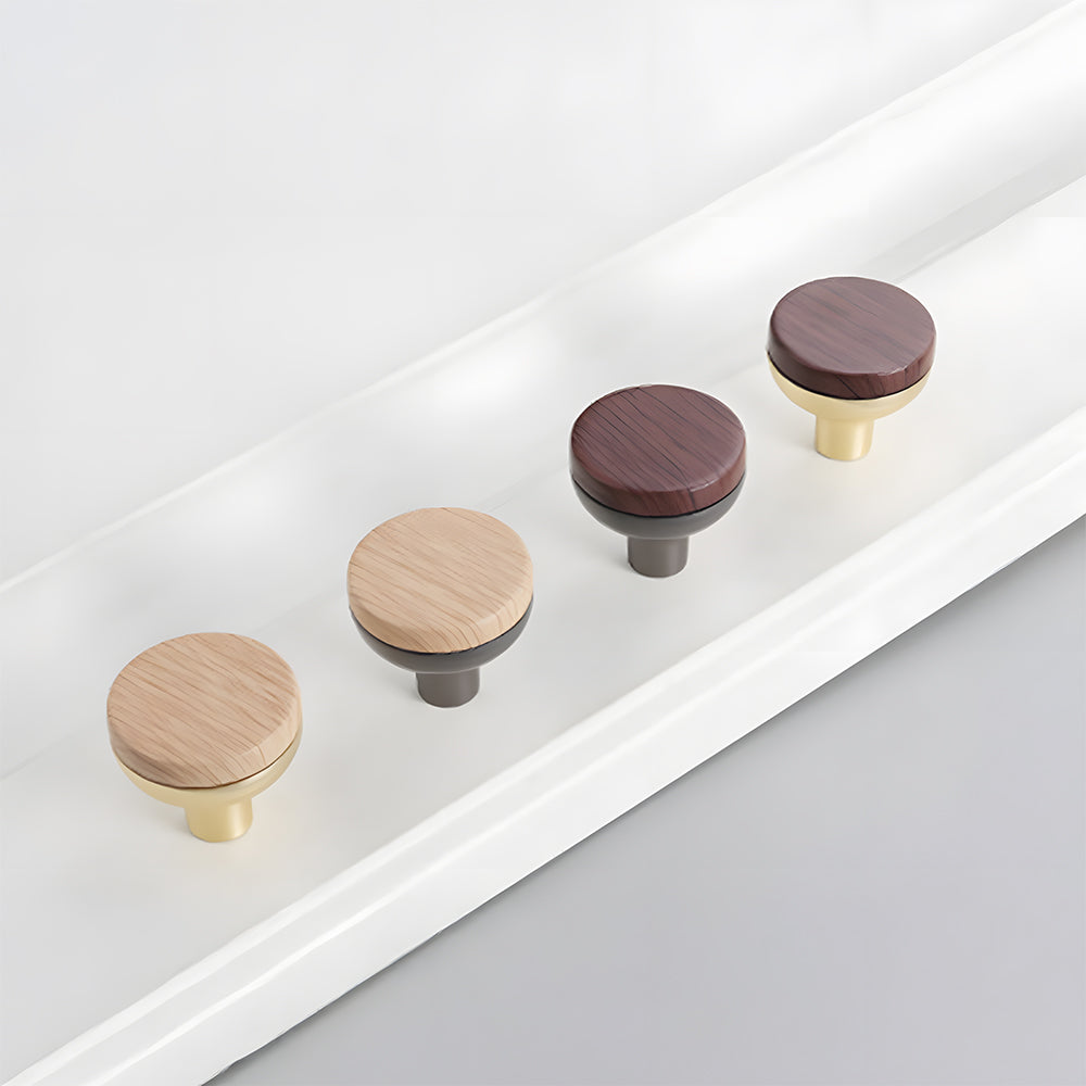 Wood-grain cabinet pull with a rounded metal base, arranged diagonally to show the visible materials and profiles