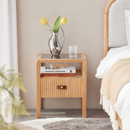 Wood-grain cabinet pull with round black or gold metal posts, shown across a complete storage cabinet in a room setting