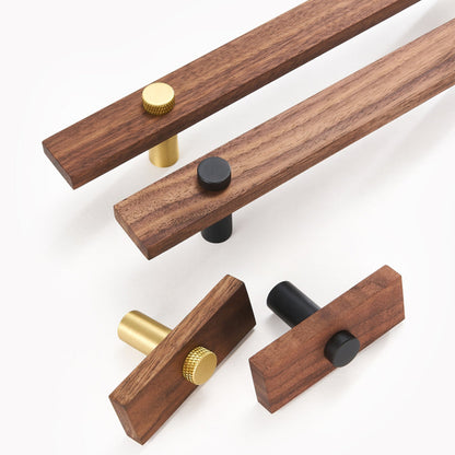 Wood-grain cabinet pull with metal posts, arranged together from an overhead angle for comparison