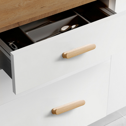 Rounded wood cabinet pull in light wood with 128 mm centers, shown across several drawer fronts in a cabinet scene