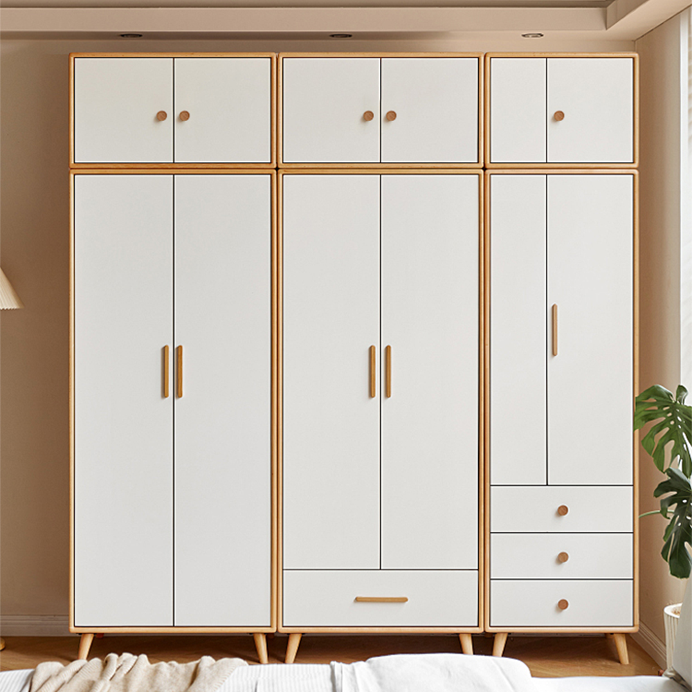 Rounded wood cabinet pull in a light or coffee finish, installed vertically on paired wardrobe doors