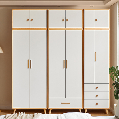 Rounded wood cabinet pull in a light or coffee finish, installed vertically on paired wardrobe doors