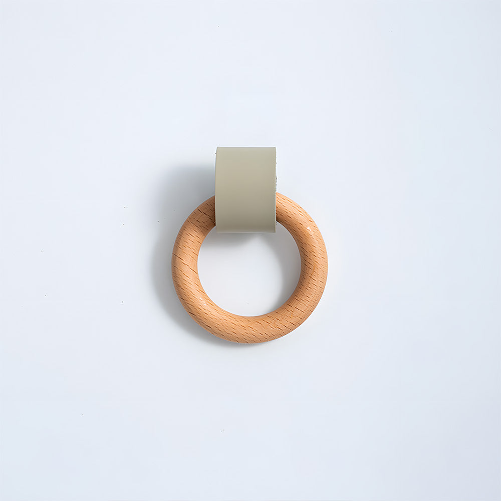 Wood ring cabinet knob with a green leather strap in a straight-on view on a white background