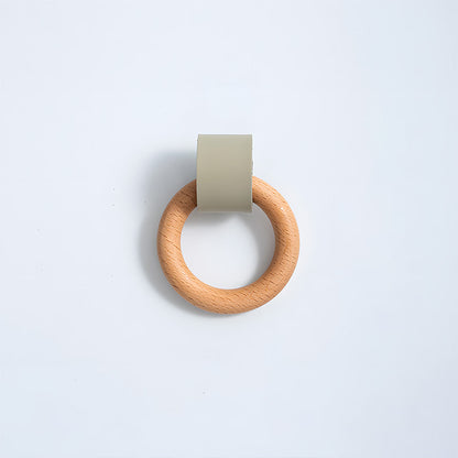 Wood ring cabinet knob with a green leather strap in a straight-on view on a white background