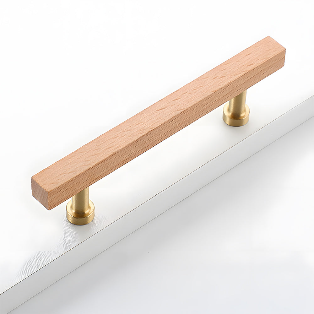 Square wood cabinet pull with round brass bases, shown from a close side angle against a plain surface