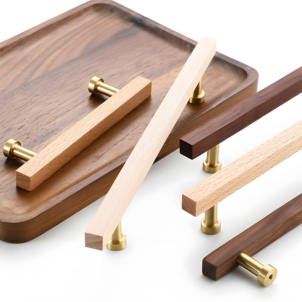 Square wood cabinet pull with round brass bases, grouped on a light surface to compare lengths and profiles