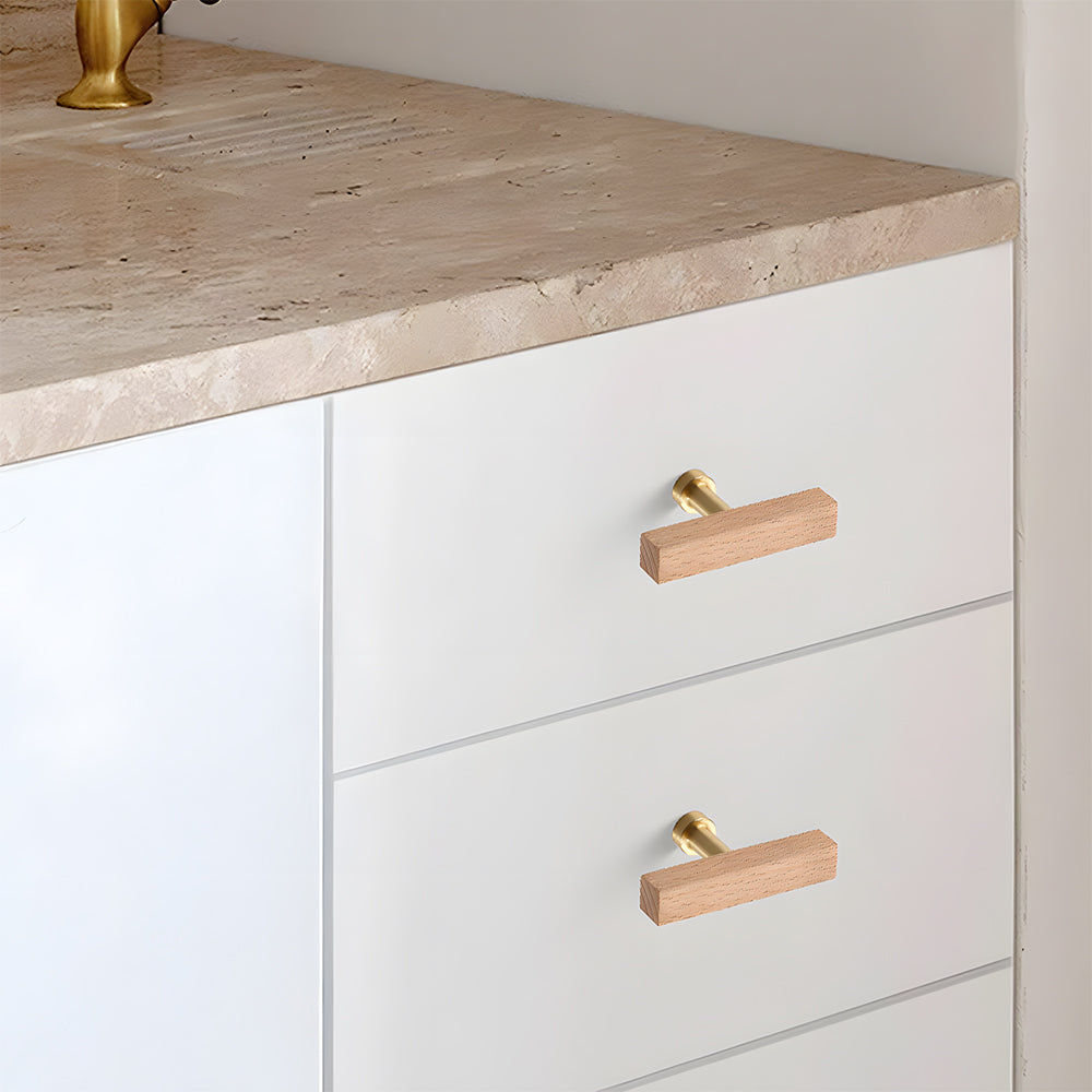 Square wood cabinet pull as a white single-hole version, installed horizontally on a drawer front in a close view
