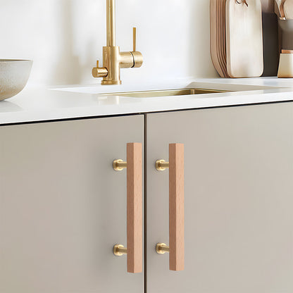 Square wood cabinet pull in white with 128 mm centers, installed on kitchen cabinet doors and drawers