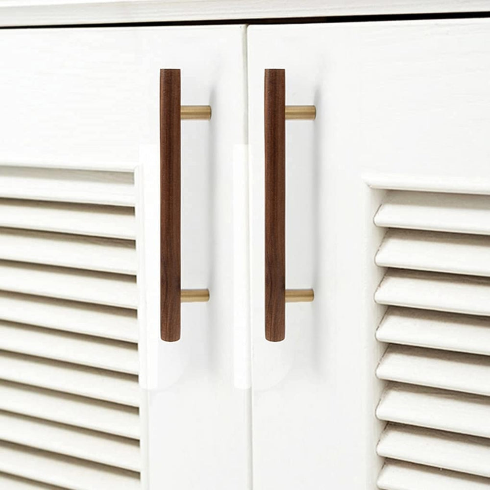 Wood cabinet pull with brass posts in brown with 128 mm centers, installed on cabinet doors in a close furniture view
