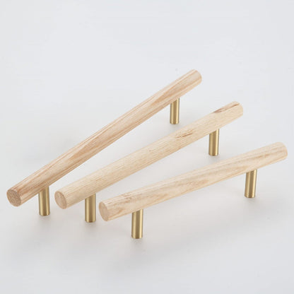 Wood cabinet pull with brass posts, grouped in long and short versions on a neutral surface