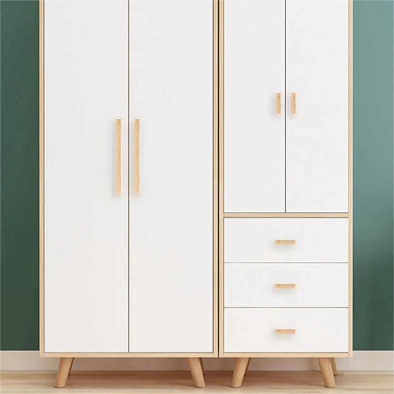 Wood cabinet pull with brass posts in ash wood with 224 mm centers, mounted as matching hardware on double cabinet doors