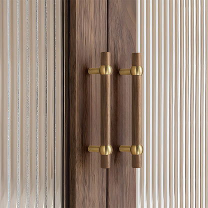 Wood round bar cabinet pull in brown with 128 mm centers, shown on cabinet fronts in a bright room setting