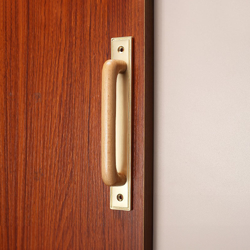 Wood cabinet pull with a rectangular metal backplate, presented in another view installed on cabinetry in context