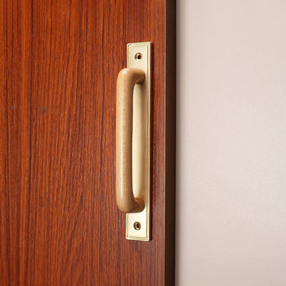 Wood cabinet pull with a rectangular metal backplate, presented in another view installed on cabinetry in context