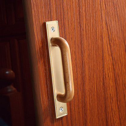 Wood cabinet pull with a rectangular metal backplate, shown from one angle mounted on a finished cabinet front