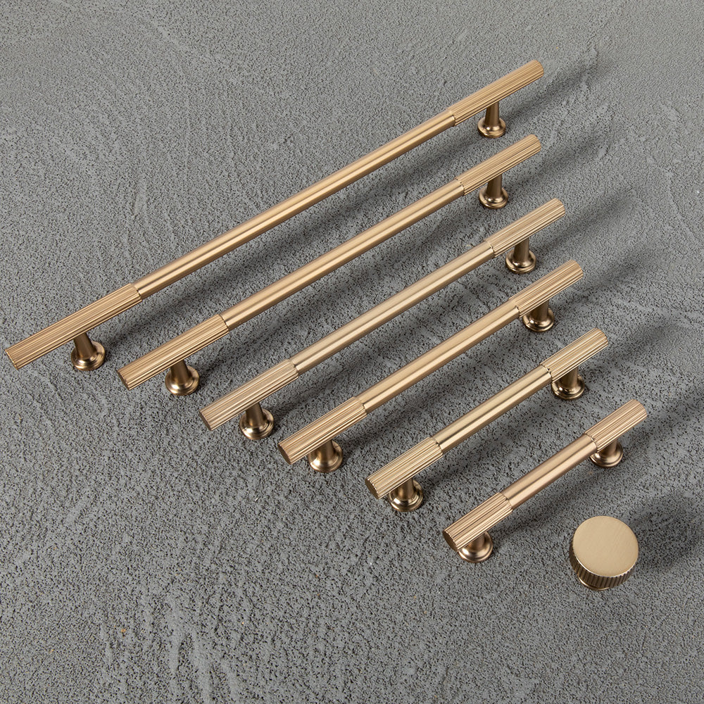 Matte gold fluted bar cabinet pull and round knob, presented in another view as a color and finish lineup