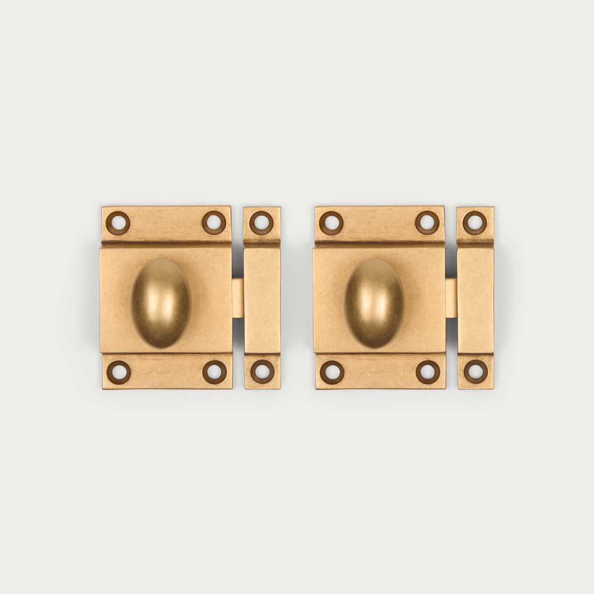 Two antique brass cabinet latches shown side-by-side on a light gray background.