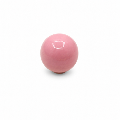 Pink ceramic ball cabinet knob on a white background